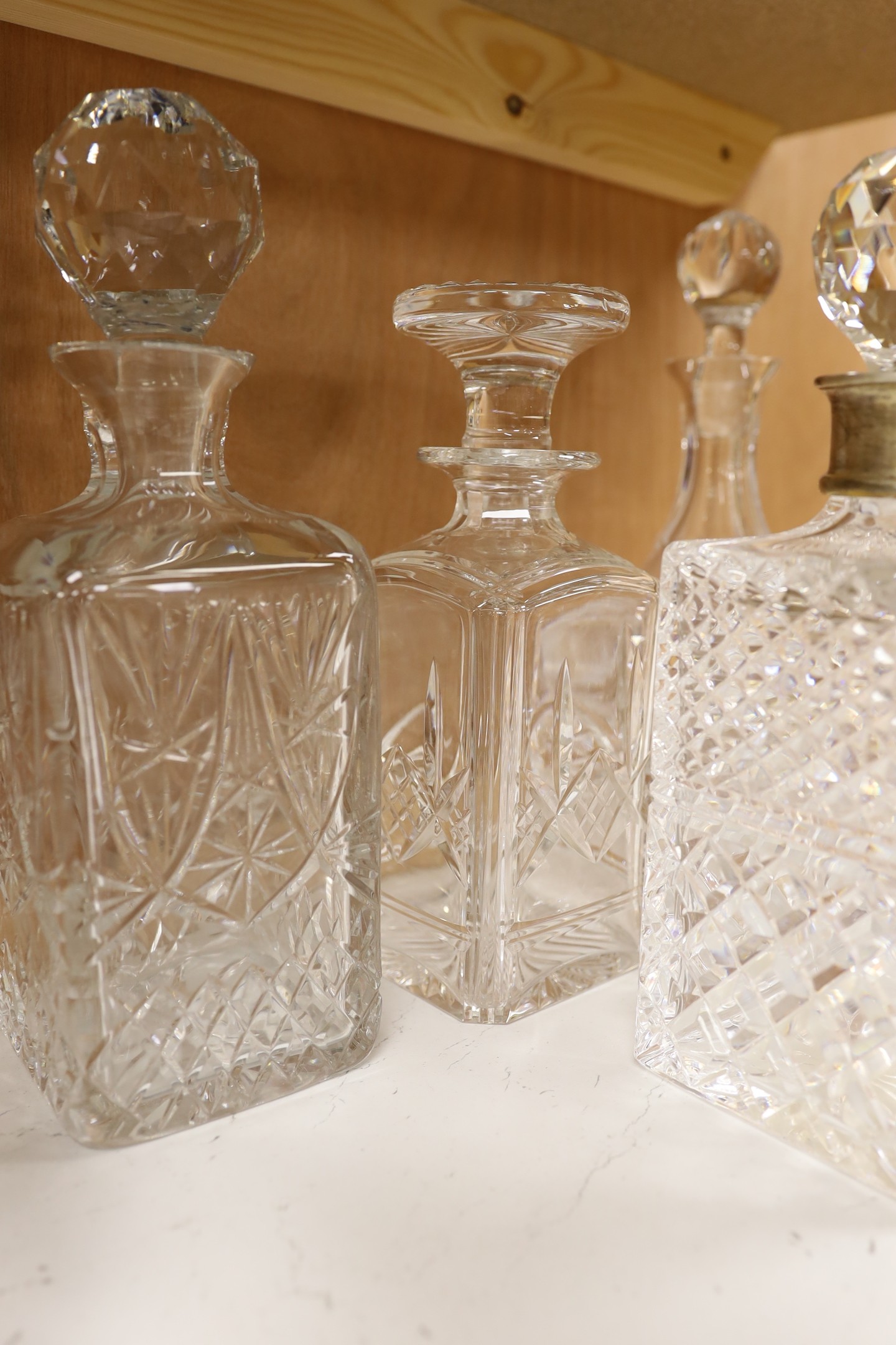 A silver mounted decanter, four others and a smaller pair of decanters, tallest 27.5cm